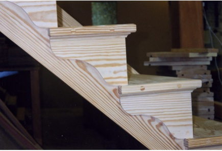 Open and cut string with bracketed return staircase manufactured in southern yellow pine